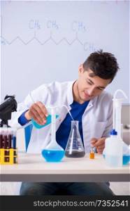 Young chemist sitting in the lab 