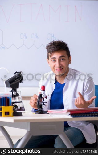 Young chemist sitting in the lab 