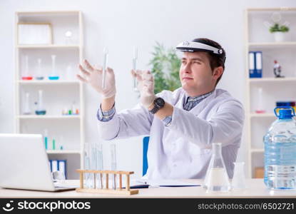 Young chemist student experimenting in lab