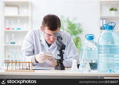 Young chemist student experimenting in lab