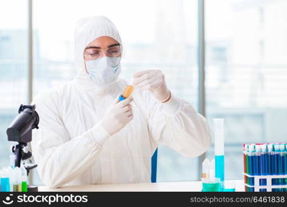 Young chemist student working in lab on chemicals