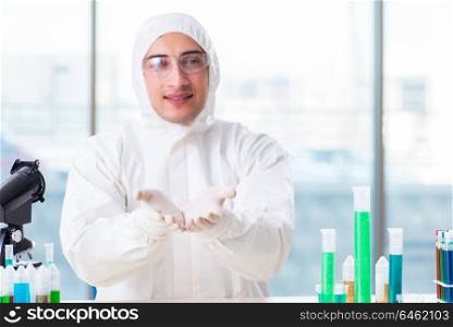 Young chemist student working in lab on chemicals