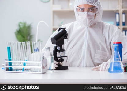 Young chemist student working in lab on chemicals