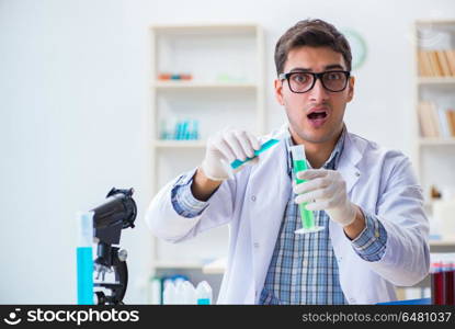 Young chemist student working in lab on chemicals