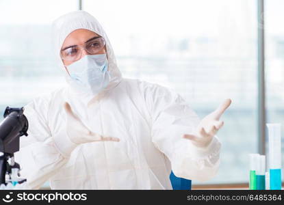 Young chemist student working in lab on chemicals