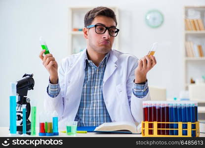 Young chemist student working in lab on chemicals