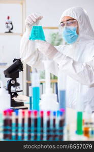 Young chemist student working in lab on chemicals