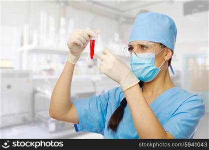 Young chemist with vial on lab