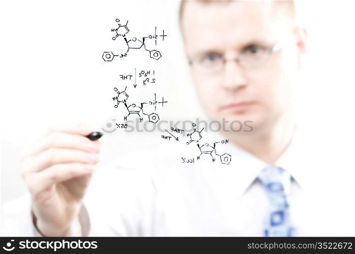 young chemist writing organic chemistry reaction equation, selective focus