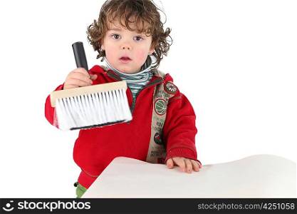 Young child holding a brush
