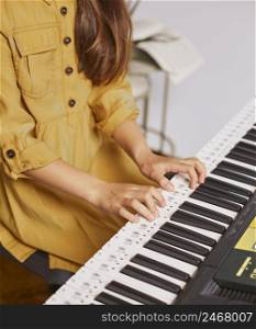 young child learning how play electronic keyboard