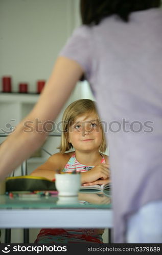 Young child looking up to her mother