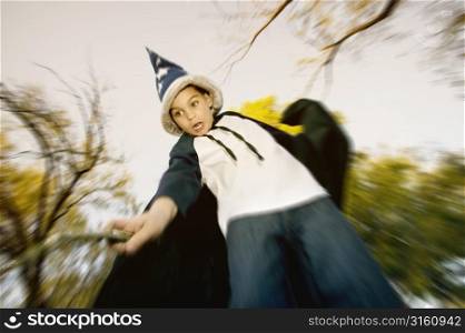 Young child pretending to be a wizard