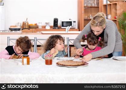Young children eating crepes