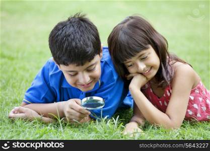 Young children with magnifying glass