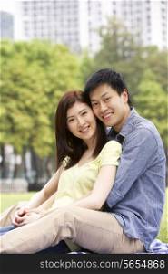 Young Chinese Couple Relaxing In Park Together