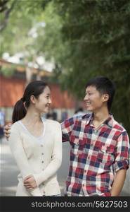 Young Chinese Couple Walking In Jing Shan Park