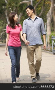 Young Chinese Couple Walking In Park