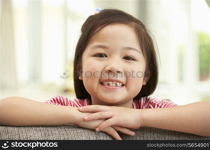 Young Chinese Girl Relaxing On Sofa At Home