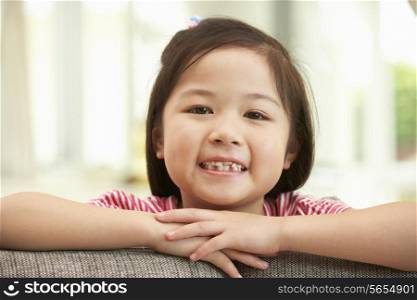 Young Chinese Girl Relaxing On Sofa At Home