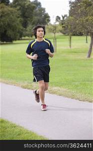Young Chinese man jogging at park