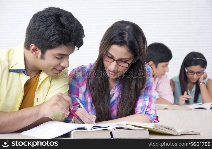 Young college friends studying in classroom