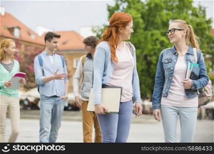 Young college friends walking on street