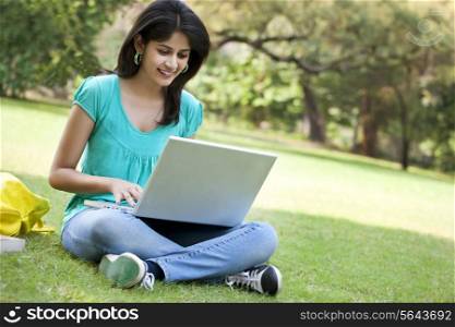 Young college student using laptop