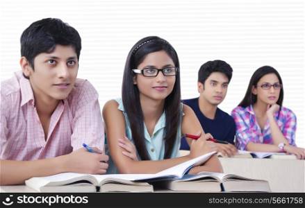 Young college students listening to lecture in classroom