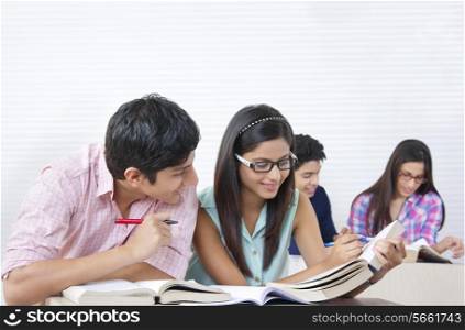 Young college students studying in classroom