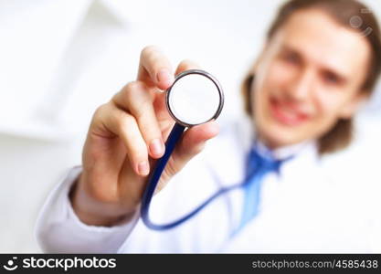 Young confident and friendly doctor in medical office