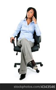 Young confident black businesswoman on phone sitting in leather office chair