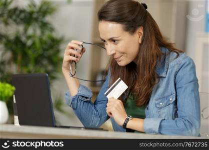 young confident pretty woman working with laptop at home