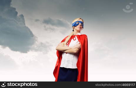 Young confident woman in super hero costume