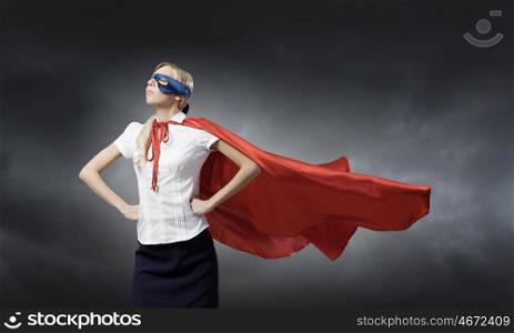 Young confident woman in super hero costume