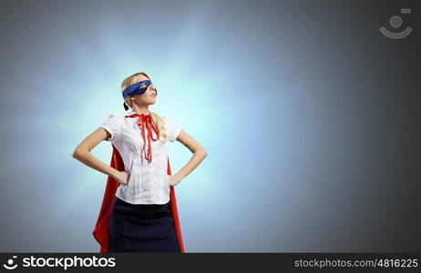 Young confident woman in super hero costume