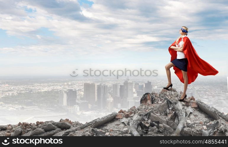 Young confident woman in super hero costume