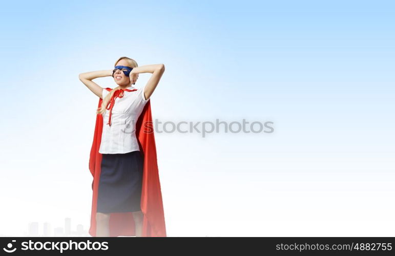 Young confident woman in super hero costume