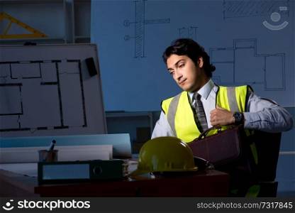 Young construction architect working on project at night 