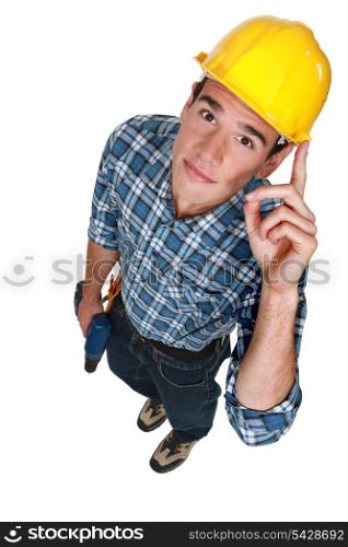 Young construction worker with a drill