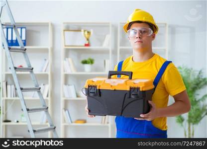 Young contractor doing repair works at office 