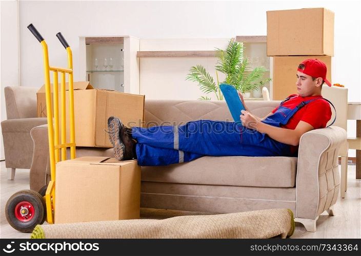 Young contractor with boxes working indoors 