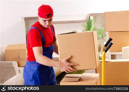 Young contractor with boxes working indoors 