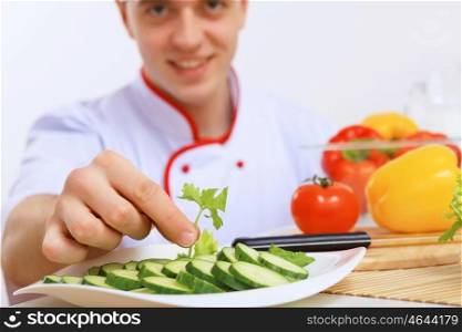 Young cook preparing food from fresh vegetables