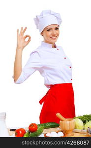 Young cook preparing food wearing a red apron