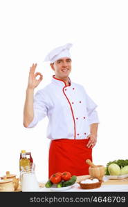 Young cook preparing food wearing a red apron