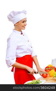 Young cook preparing food wearing red apron