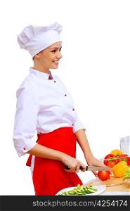 Young cook preparing food wearing red apron