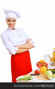 Young cook preparing food wearing red apron