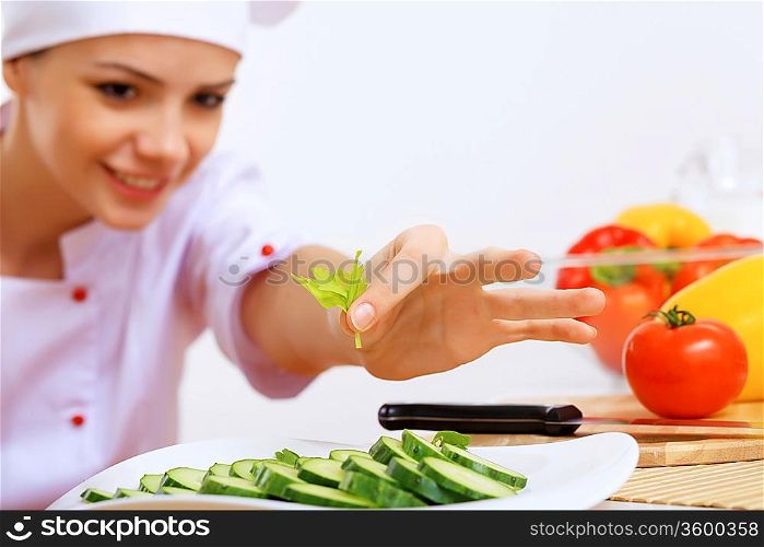 Young cook preparing food with red apron